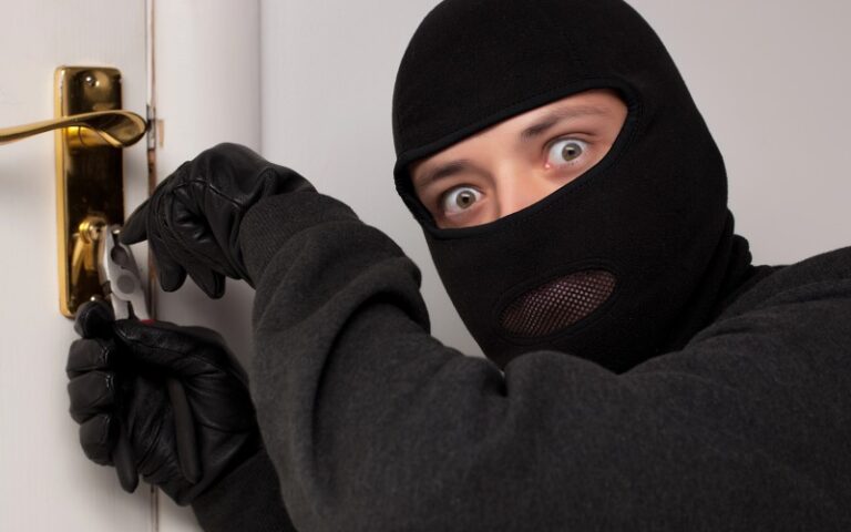 Burglar attempting to break into door lock - D and L Locksmith